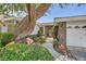 Brick entryway with wrought iron gate and mature tree at 7456 Ute Meadows Cir, Las Vegas, NV 89129