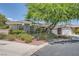 Single-story home with gray siding, mature tree, and two-car garage at 7456 Ute Meadows Cir, Las Vegas, NV 89129