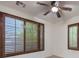 Well-lit bedroom with plantation shutters and ceiling fan at 7525 Royal Crystal St, Las Vegas, NV 89149