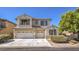 Two-story house with a three-car garage and landscaped front yard at 7525 Royal Crystal St, Las Vegas, NV 89149