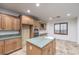 Kitchen with island, wood cabinets, and built-in workspace at 7525 Royal Crystal St, Las Vegas, NV 89149