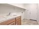 Laundry room with sink, cabinets, and shelving at 7525 Royal Crystal St, Las Vegas, NV 89149