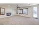 Living room with fireplace, sliding door to backyard, and ceiling fan at 7525 Royal Crystal St, Las Vegas, NV 89149