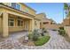 Backyard patio with pavers, fire pit, and landscaping at 8031 Tank Loop St, Las Vegas, NV 89166