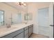 Modern bathroom with double vanity and gray cabinets at 8031 Tank Loop St, Las Vegas, NV 89166