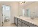 Bathroom with double vanity, gray cabinets, and toilet at 8031 Tank Loop St, Las Vegas, NV 89166