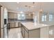 Modern kitchen with gray cabinets, island, and stainless steel appliances at 8031 Tank Loop St, Las Vegas, NV 89166