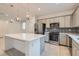 Modern kitchen with gray cabinets, stainless steel appliances, and an island at 8031 Tank Loop St, Las Vegas, NV 89166