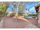 Landscaped backyard with gravel and mature trees at 8220 Fawn Heather Ct, Las Vegas, NV 89149