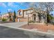 Two-story house with three-car garage and gravel landscaping at 8220 Fawn Heather Ct, Las Vegas, NV 89149