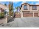 Two-story house with an ornate gate and three-car garage at 8220 Fawn Heather Ct, Las Vegas, NV 89149