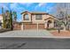 Two-story house with three-car garage and landscaped yard at 8220 Fawn Heather Ct, Las Vegas, NV 89149