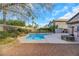 Relaxing kidney shaped pool with a stone fire pit and patio at 8220 Fawn Heather Ct, Las Vegas, NV 89149