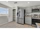 Well-lit kitchen with stainless steel appliances, granite countertops, and convenient pantry storage at 840 Picotte St # 101, Las Vegas, NV 89144