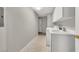 The laundry room has a tile floor with a washer, dryer, sink and white cabinets at 840 Picotte St # 101, Las Vegas, NV 89144