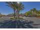 Community entrance with palm trees and circular driveway at 8777 W Maule Ave # 1094, Las Vegas, NV 89148