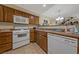 Kitchen with white appliances and wood cabinets at 8777 W Maule Ave # 1094, Las Vegas, NV 89148