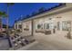 Backyard patio with seating area, steps leading to pool, and landscape lighting at 9390 Stange Ave, Las Vegas, NV 89129