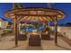 Gazebo with fire pit and seating area overlooking the pool at 9390 Stange Ave, Las Vegas, NV 89129