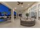 Outdoor patio area with wicker furniture and ceiling fans at 9390 Stange Ave, Las Vegas, NV 89129