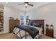 Spacious bedroom with a wooden bed frame and large windows at 9390 Stange Ave, Las Vegas, NV 89129