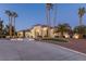 Stunning curb appeal of a large luxury home with palm trees and a long driveway at 9390 Stange Ave, Las Vegas, NV 89129