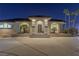 Elegant home with a dramatic entryway at night at 9390 Stange Ave, Las Vegas, NV 89129