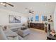 Spacious living room with light colored sectional sofa and wooden media console at 9390 Stange Ave, Las Vegas, NV 89129