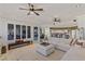 Living room with sectional sofa, wooden bench and kitchen view at 9390 Stange Ave, Las Vegas, NV 89129