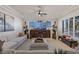 Bright living room with comfortable seating, large TV, and wood accent wall at 9390 Stange Ave, Las Vegas, NV 89129