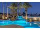 Luxury pool with waterfall feature at night at 9390 Stange Ave, Las Vegas, NV 89129