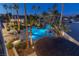 Inviting pool and spa with palm trees and outdoor lighting at 9390 Stange Ave, Las Vegas, NV 89129