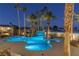 Irregular shaped pool with waterfall feature at night at 9390 Stange Ave, Las Vegas, NV 89129