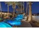 Luxury pool with waterfall feature at night at 9390 Stange Ave, Las Vegas, NV 89129