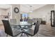 Bright dining area with glass table and view into the living room at 9520 Yucca Blossom Dr, Las Vegas, NV 89134