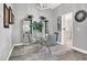 Modern dining area with glass table and gray chairs at 9520 Yucca Blossom Dr, Las Vegas, NV 89134