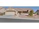 Single-story home with a two-car garage and nicely landscaped front yard at 9520 Yucca Blossom Dr, Las Vegas, NV 89134