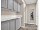 Clean hallway with gray cabinets and a full-length mirror at 9520 Yucca Blossom Dr, Las Vegas, NV 89134