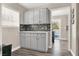 Bright laundry room with gray cabinets and backyard access at 9520 Yucca Blossom Dr, Las Vegas, NV 89134