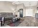 Open living room with gray sectional sofa and wood-look flooring at 9520 Yucca Blossom Dr, Las Vegas, NV 89134