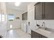 Bright laundry room with modern cabinets and a utility sink at 1 Panorama Crest Ave, Las Vegas, NV 89135