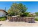 Outdoor kitchen with bar seating at 1 Panorama Crest Ave, Las Vegas, NV 89135