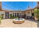 Outdoor patio with fireplace, seating, and string lights at 1 Panorama Crest Ave, Las Vegas, NV 89135