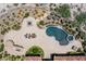 Aerial view of a kidney shaped pool and spa with surrounding landscaping at 1 Panorama Crest Ave, Las Vegas, NV 89135