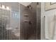 Elegant shower with dark hexagonal tiles and glass enclosure at 1 Panorama Crest Ave, Las Vegas, NV 89135