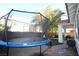 Backyard with trampoline, patio furniture, and a covered patio at 10418 Prairie Mountain Ave, Las Vegas, NV 89166