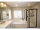 Spa-like bathroom with a large soaking tub and shower at 10418 Prairie Mountain Ave, Las Vegas, NV 89166