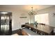 Bright dining room features a farmhouse table, bench seating, and chandelier at 10418 Prairie Mountain Ave, Las Vegas, NV 89166