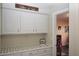 Bright laundry room with white cabinets and a washer and dryer at 10418 Prairie Mountain Ave, Las Vegas, NV 89166