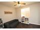 Cozy ' room featuring a sofa, bookcase, and window at 10418 Prairie Mountain Ave, Las Vegas, NV 89166